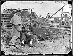 Wounded soldier in deserted camp