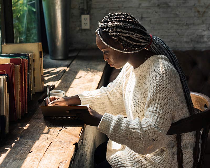 black woman writing a book