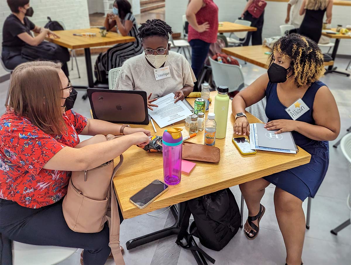 three young scholars in discussion