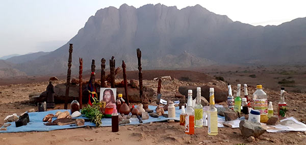 shamanic ritual artifacts in front of a mountain