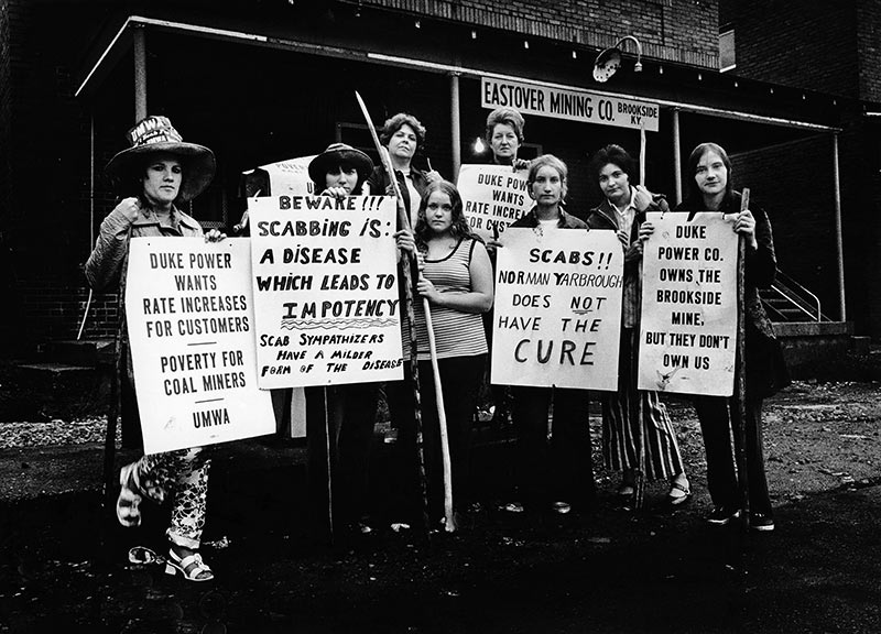 women holding protest signs