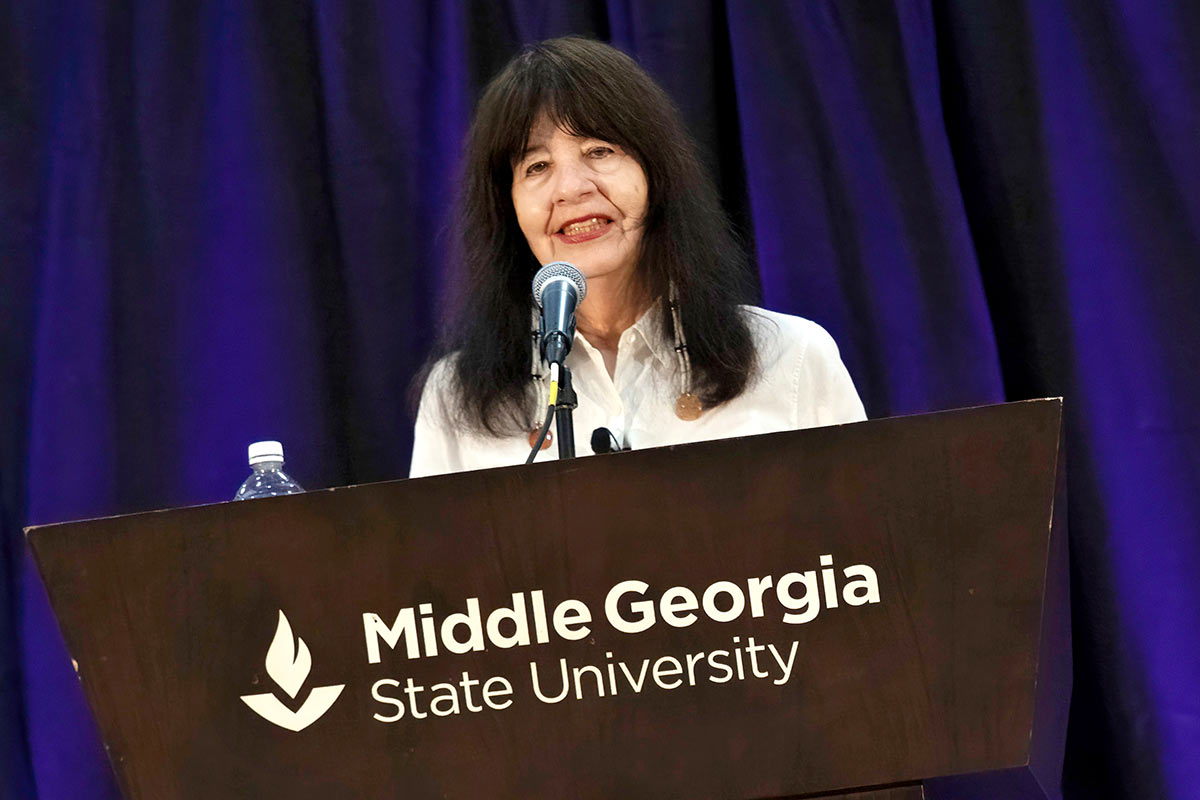 Joy Harjo delivers a poetry reading at Middle Georgia State University. Courtesy of Georgia Humanities, photo by Jessica Whitley.