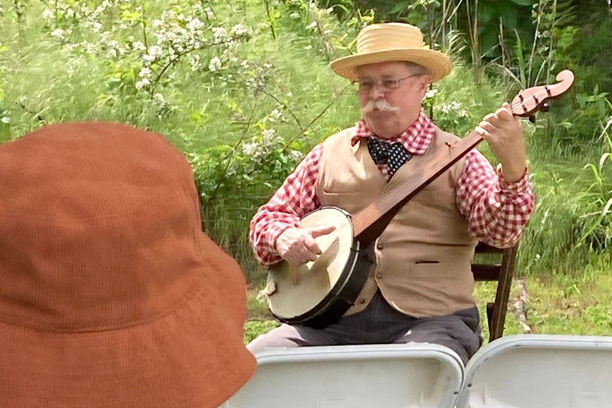 Musician Clarke Buehling performs music on his banjo that nineteenth century settlers would have heard in Arkansas at the time. Photo courtesy of Historic Cane Hill.