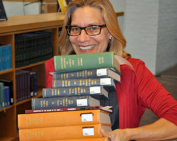 Linda Rupert with an armful of books